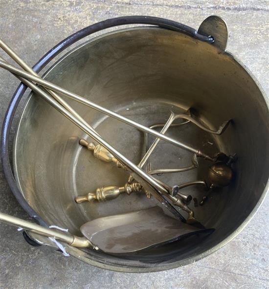 A Victorian brass preserve pan, diameter 36cm, a set of brass fire implements and a pair of fire dogs